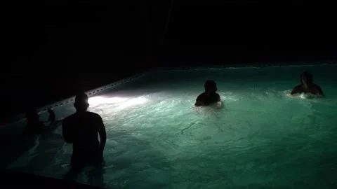 A man jumping into the pool with pants and his friends celebrating and shouting Video stock 170015037
