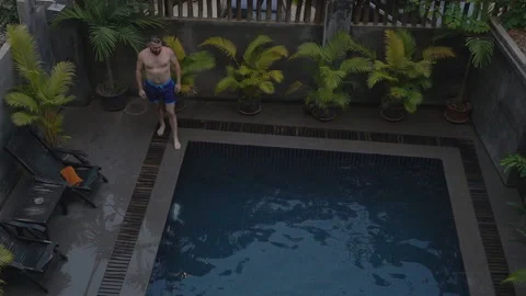 Man jumping to the pool, slow motion shot at 240fps  Stock Footage 102043032
