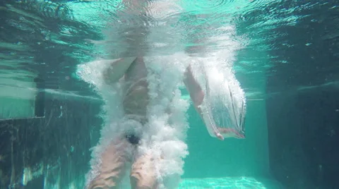 Man jumping into the pool, underwater shot Video stock 50864233