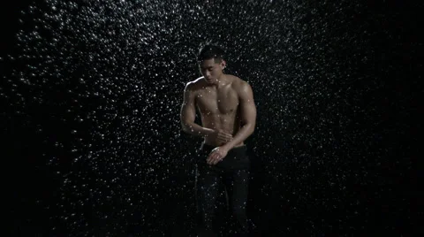 Man jumping in rain Stock Footage 47564646