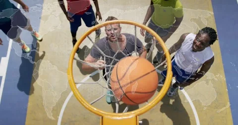 Man jumping releasing ball, under-hoop teammate pulling through net to score, Stock Footage 321070945