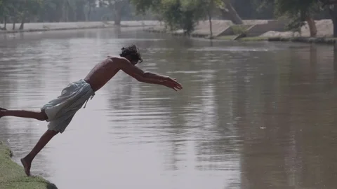 Man jumping in the river Stock Footage 90679989