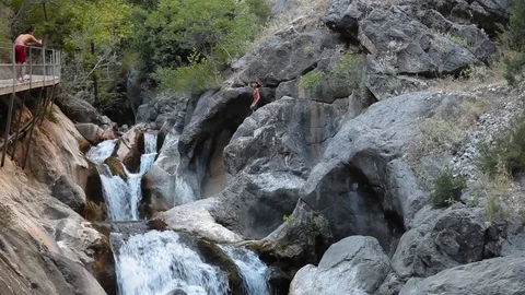 Man is Jumping Into the River Waterfall Stock Footage 125781638
