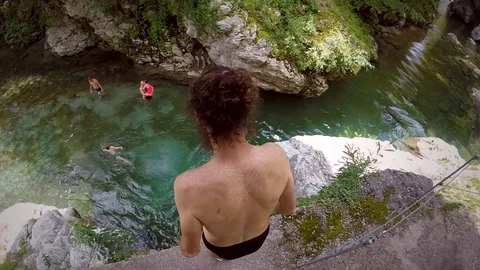 Man jumping from rock into river in Soca valley, Slovenia. Stock Footage 97062342
