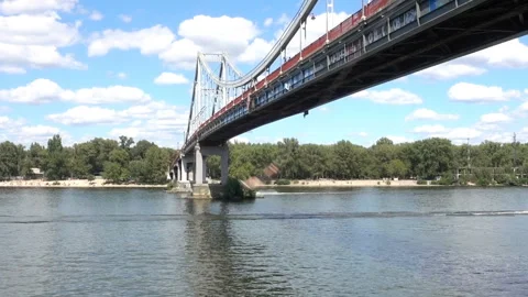 A man jumping on a rope from a river bridge and ships Stock Footage 154857620