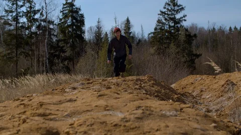 Man jumping on a sand hill Stock Footage 128862674