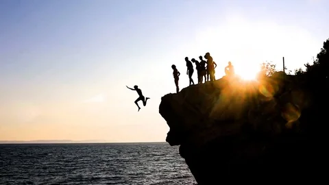 Man Jumping into The Sea with Group Looking Vídeo Stock 96773285