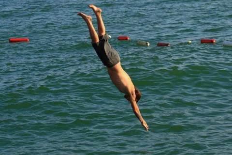 Man jumping into the sea Stock Photos