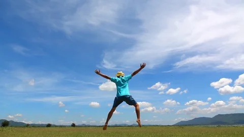 A man jumping slow motion and cloud sky background. Stock Footage 108778586