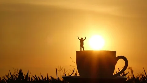 A man jumping slow motion on a coffee cup. sunset and cloud sky time lapse. Stock Footage 107402570
