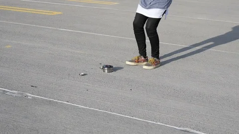 Man jumping on a smashed alarm clock on concrete Stock Footage 90509552