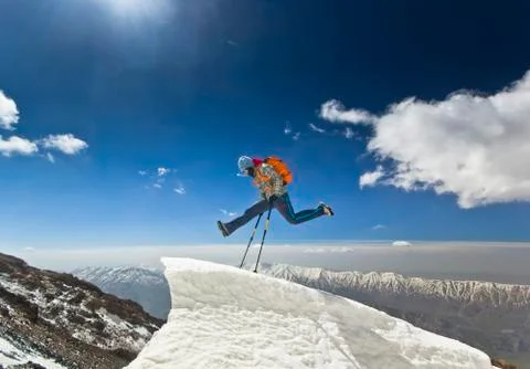 Man jumping on a snow cornice in mountain sunrise Stock Photos