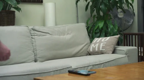 Man jumping on the sofa, slow motion shot at 120fps, steadycam shot Stock Footage 38554112