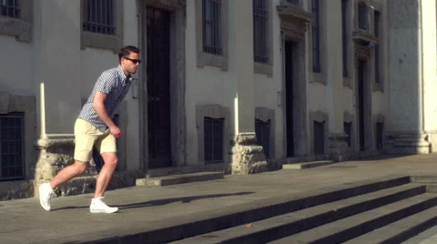 Man jumping on the square in the city, steadycam shot, slow motion shot at 240fp 스톡 동영상 56036080