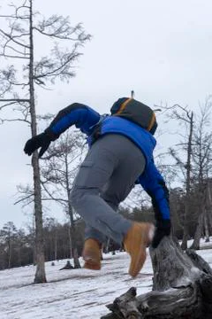 Man jumping from stump in pine forest, digital painting of landscape image wi Stock Photos