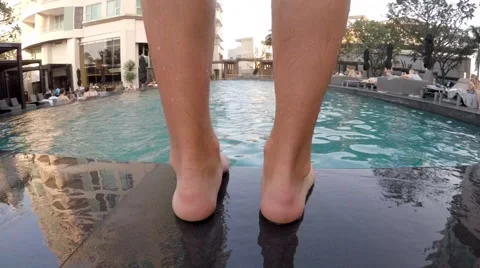 Man Jumping to the Swimming Pool from the Border Stock Footage 61777836