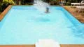 Man Jumping in Swimming Pool. Slow Motion. HD Footage