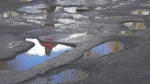 Man is Jumping Through Puddles Water in Pits Running by Wet Road Feet Close up Stock Footage 60860328