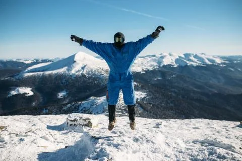 A man is jumping on top of a mountain Stock Photos