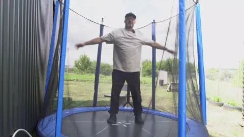 A man jumping on a trampoline 4K Stock Footage 325988127