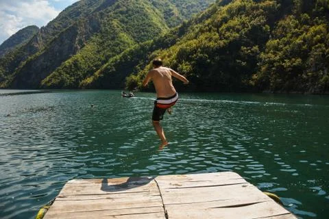 Man jumping in the water Stock Photos