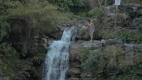 Man Jumping Off Waterfall at Da Gia, Vietnam – Feb 26 Stock Footage 303035960
