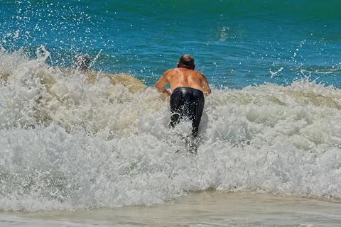 Man jumping into a wave Foto stock