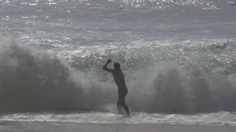 Man Jumping into Wave Slow Motion Stock Footage 106783951