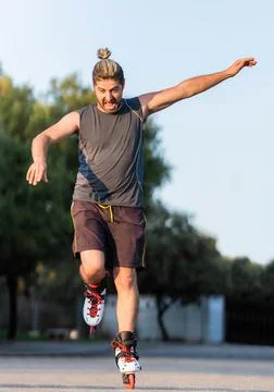 Man jumping while skating with inline skates outdoors Stock Photos