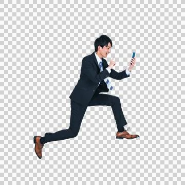 A man jumping while using a smartphone. Foto stock
