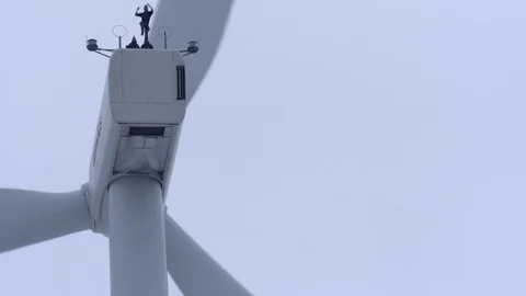 Man jumping from windmill with parachute Stock Footage 74908400