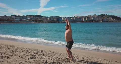 A man jumps on the beach sideways Stock Footage 171527816
