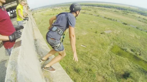 Man jumps facing forward waving Stock Footage 68071229