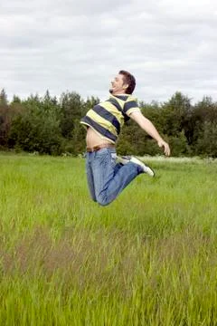 Man jumps on a grass Stock Photos