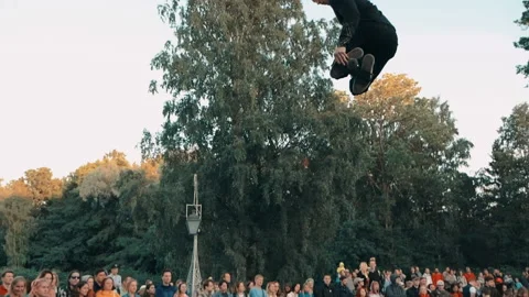 Man jumps high on jumper, performs dangerous stunts from jumper to japing show. Stock Footage 160759557
