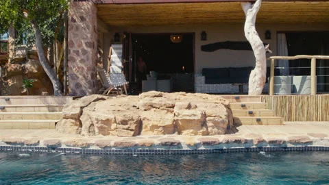 Man jumps into an infity pool Stock Footage 135131415