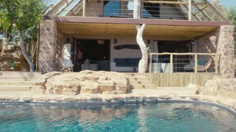 Man jumps into an infity pool Stock Footage 135133478