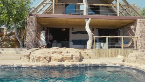 Man jumps into an infity pool Stock Footage 135134187