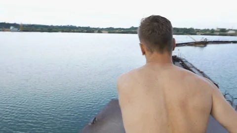 Man jumps in the lake Stock Footage 87613081