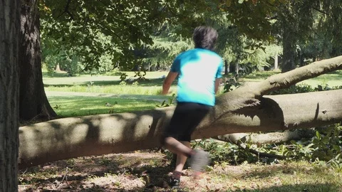 Man jumps over the trunk at the park Stock-Footage 114170083