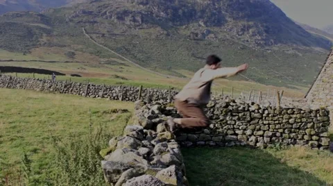 Man jumps over wall Stock Footage 41943195