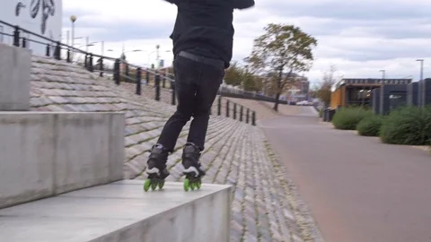Man jumps from parapet on inline skates in slow motion Stockbeeldmateriaal 120445571