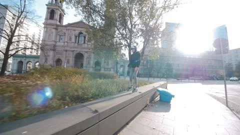 Man jumps on parapet while inline skating in the city Stock Footage 120445733