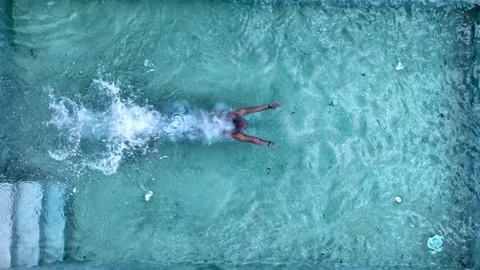 The man jumps in the pool from left side. Cool water. Slow_mo. Stock Footage 213612263