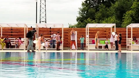 Man jumps in pool wearing Stock Footage 65457272