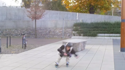 Man jumps from stone on inline skates in motion blur Stock Footage 119476459