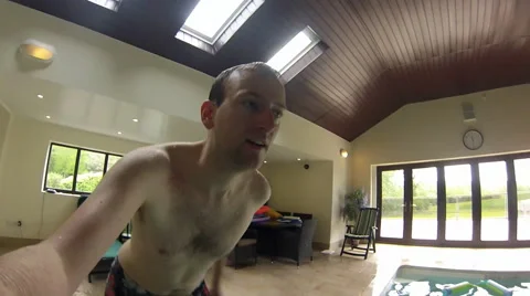Man Jumps into swimming pool Stock Footage 46726310