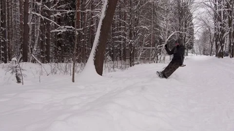 A man jumps off a swing in a winter forest. Stock Footage 146167627