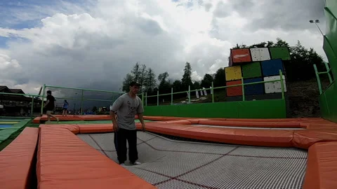 Man jumps on a trampoline and does a somersault Video stock 102324345