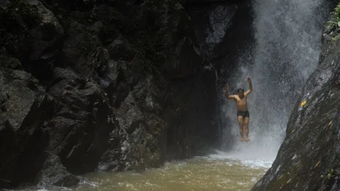 Man Jumps Into Waterfall Video stock 120545931